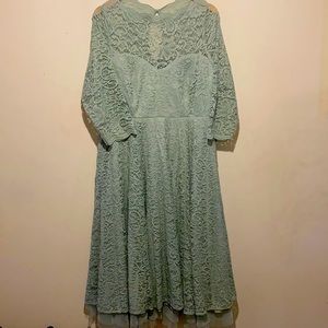 Tea-length dress with fitted waist and tulle underlay.